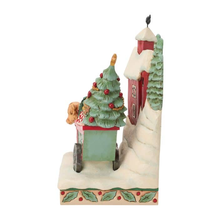 Snowy Diorama with a Tall Red House on a Snow covered Hill and Green Decorated Pine Trees on a Decorative Base