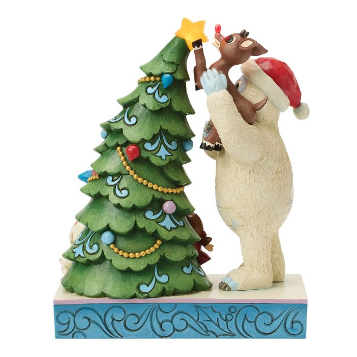 Festive Wooden Sculpture of a Reindeer Wearing a Santa Hat Kissing a Decorated Christmas Tree on a Blue Patterned Base