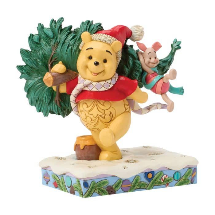 Winnie the Pooh Figure Carrying a Christmas Tree with Piglet Riding on His Back on a Snowy Decorative Base